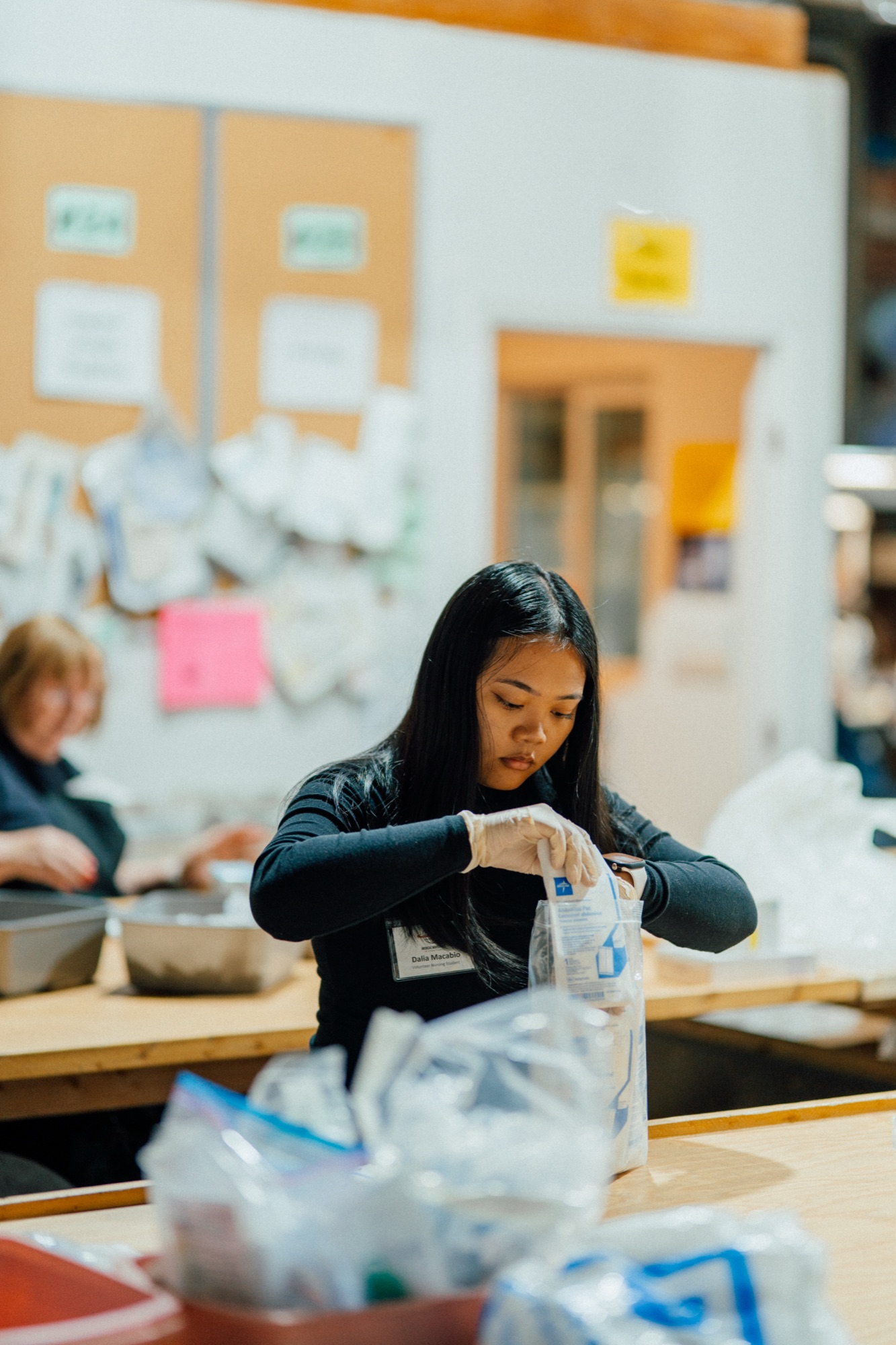 An MMI volunteer packing donated medical supplies at the Fresno warehouse