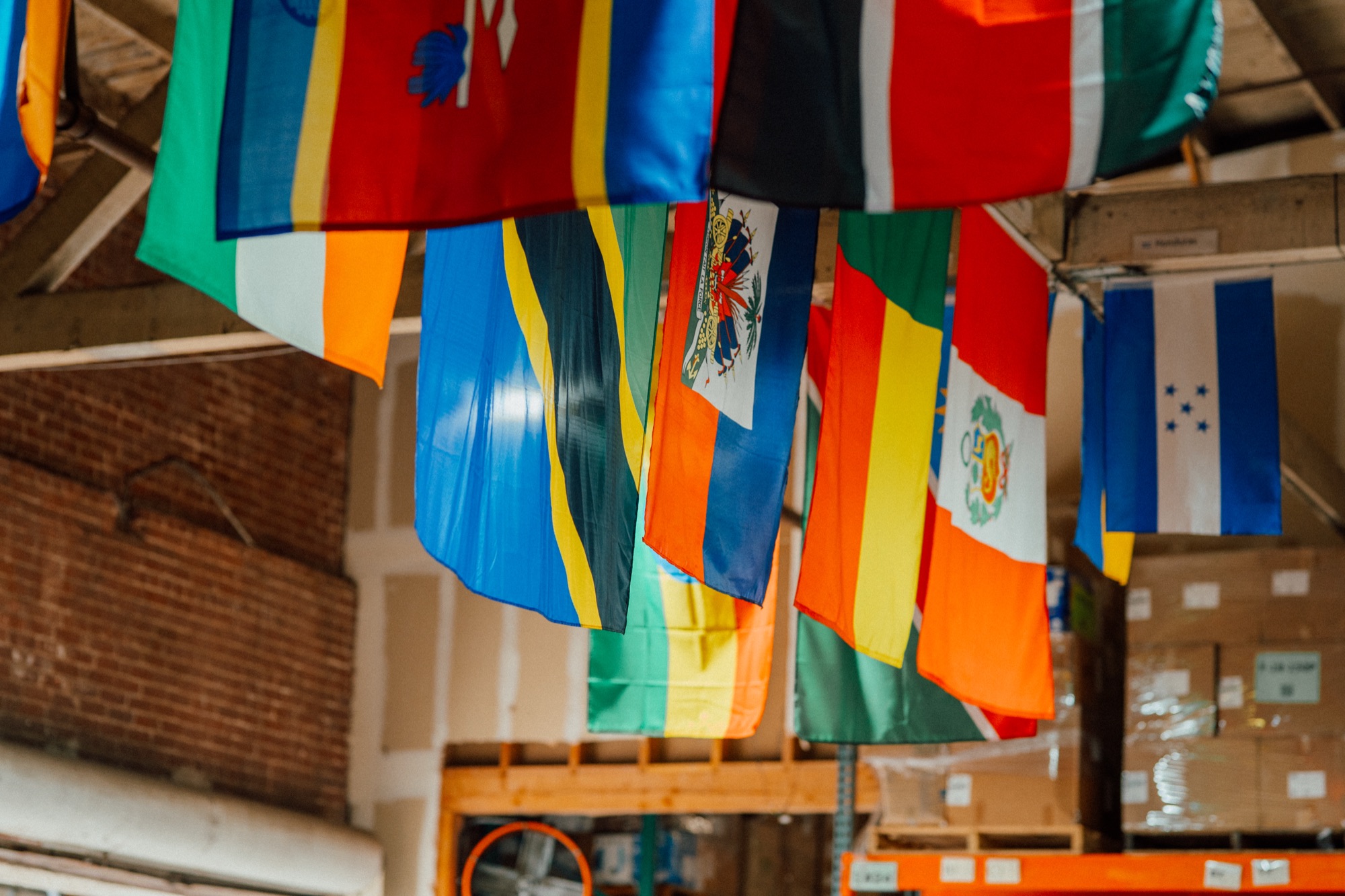 International flags hanging above warehouse storage racks