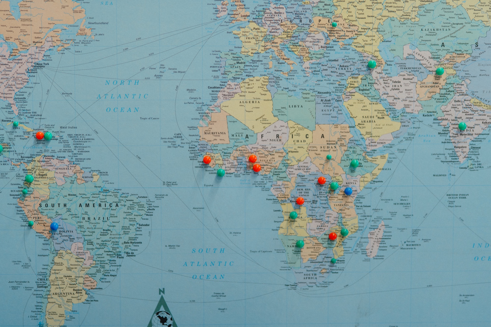 Pinned world map in the MMI Fresno warehouse marking partner hospital locations